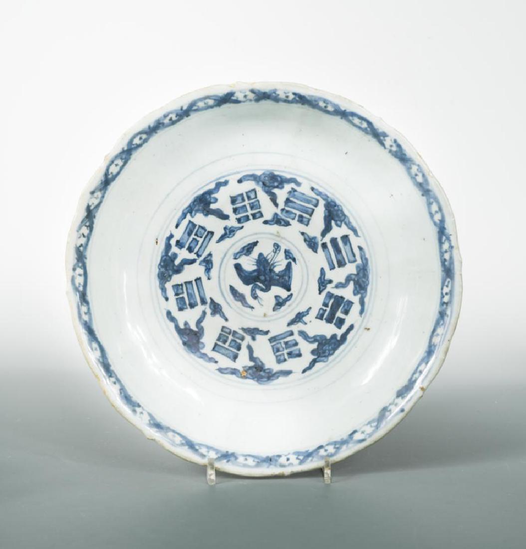 A dish with cranes and the eight trigrams, Ming: A dish with cranes and the eight trigrams, Ming dynasty, the barbed rim dish painted with a roundel to its centre representing a flying crane amongst clouds, the roundel surrounded by clouds and the b