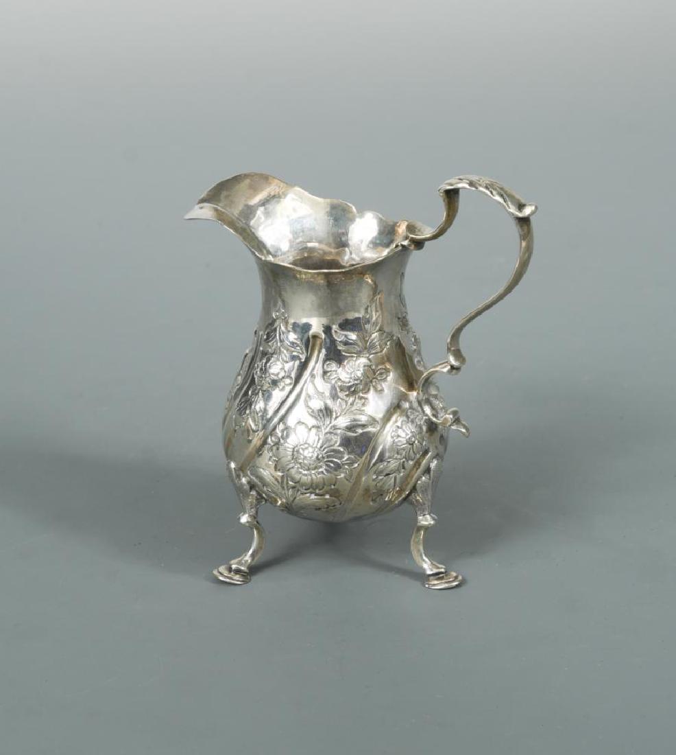 A George III silver cream jug with later decoration, (1 of 3)