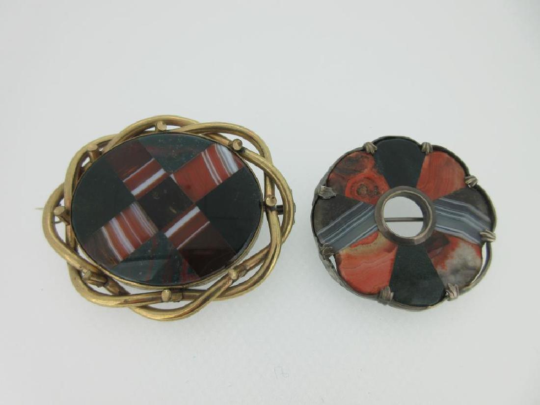 Two Scottish pebble mixed stone brooches,: Two Scottish pebble mixed stone brooches, the first of oval outline designed as a saltire and set with cornelian banded agate, bloodstone, green and brown agates in a loose twist mount, length 6.2cm;