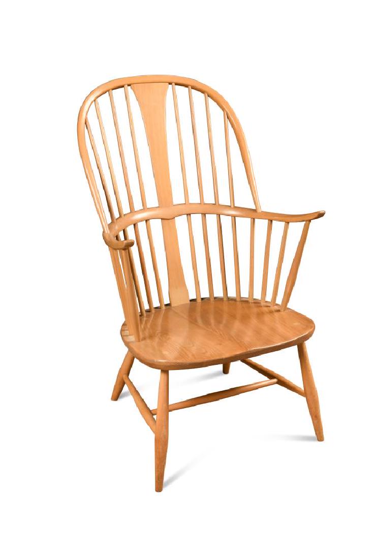 An Ercol comb-back double bow 'Chairmakers' Windsor: An Ercol comb-back double bow 'Chairmakers' Windsor armchair, with shaped seat, label to reverse 101cm (39in)
