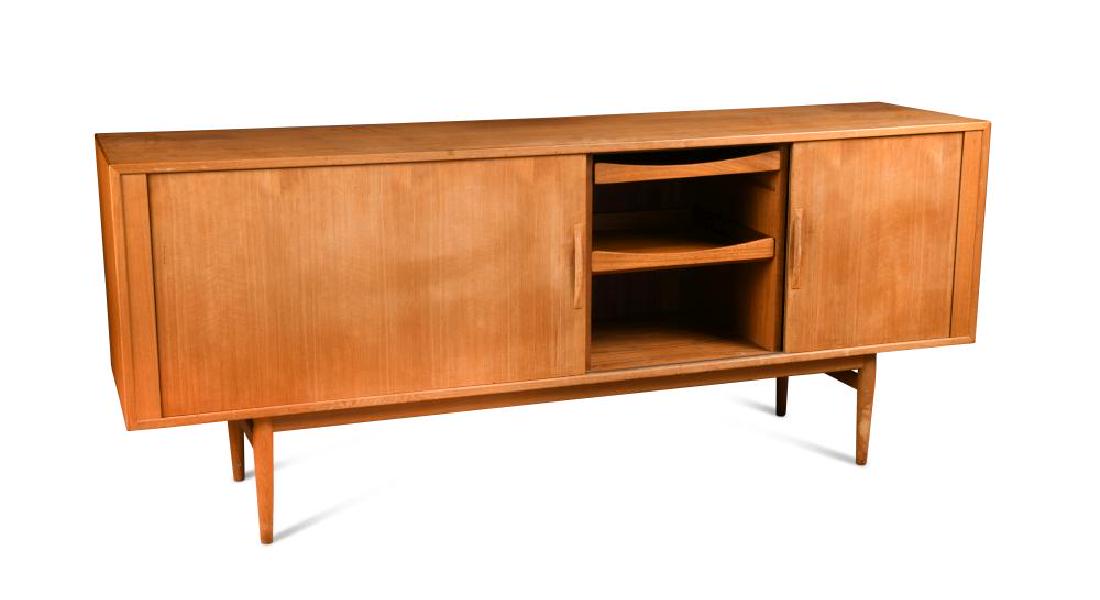 Attributed to Arne Vodder for Sibast Mobler, a Danish: Attributed to Arne Vodder for Sibast Mobler, a Danish teak sideboard, the rectangular top above a pair of tambour doors opening to reveal two central slides and shelves to either side, raised on taper