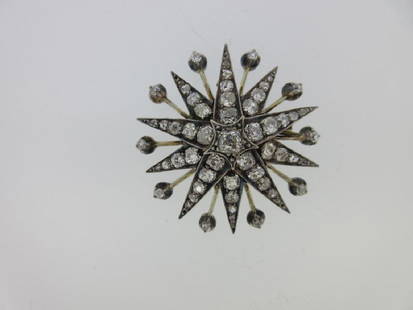 A Victorian diamond star brooch / pendant,: A Victorian diamond star brooch / pendant, the ten point star set with graduated old cushion cut diamonds with rose cuts at the tips, the points interspersed with knife-edge sparks each terminating in