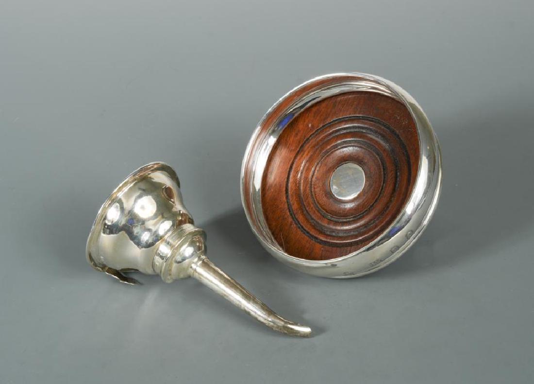 A 20th century silver wine funnel and bottle coaster,: A 20th century silver wine funnel and bottle coaster, the funnel by David Mills, London 1986, of traditional form with gadrooned rim and detachable part marked spout, the bowl with pierced base, 2ozt,