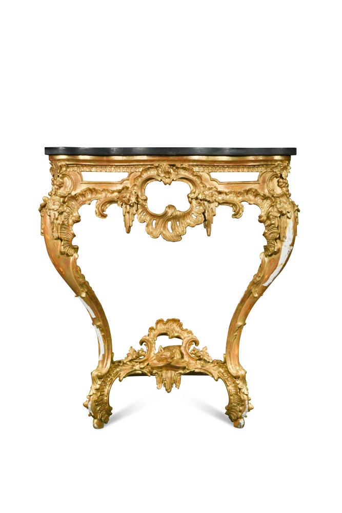 A George IV carved and pierced giltwood serpentine: A George IV carved and pierced giltwood serpentine console in the manner of Thomas Johnson, with later black marble serpentine top, the base carved with a fox to the stretcher 89 x 77 x 32cm (35 x 30