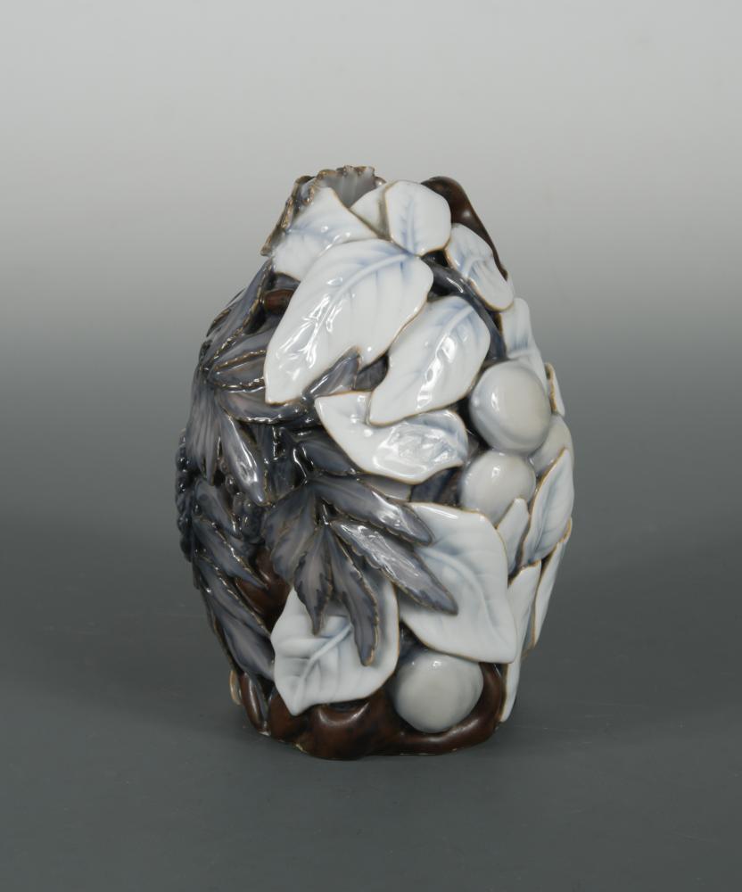 Effie Hegermann-Lindencrone (Danish, 1860-1945) for: Effie Hegermann-Lindencrone (Danish, 1860-1945) for Bing & Grøndahl, Copenhagen, a fine and probably unique porcelain vase, decorated in relief and pierced with fruiting foliate designs in pastel sha