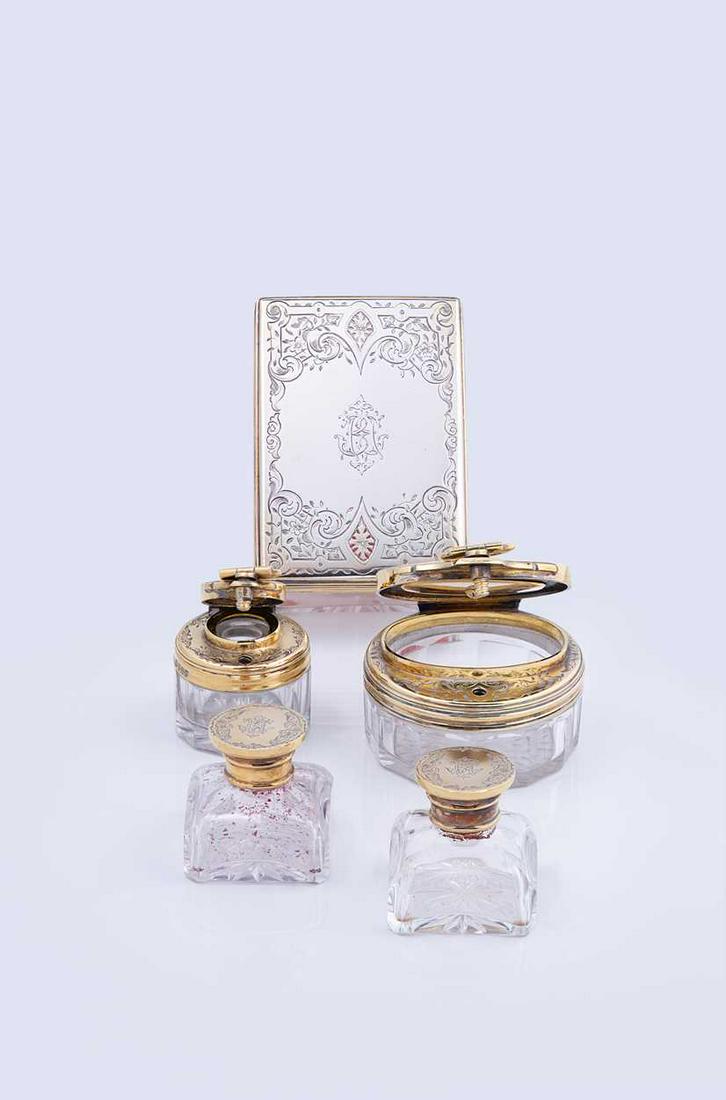 A collection of Victorian silver gilt topped glassware,: by Thomas Johnson I, London 1852/3, the tops in silver gilt and decorated with bright cut engraving around a central monogram, comprising two miniature inkwells with ground glass stoppers and screw of