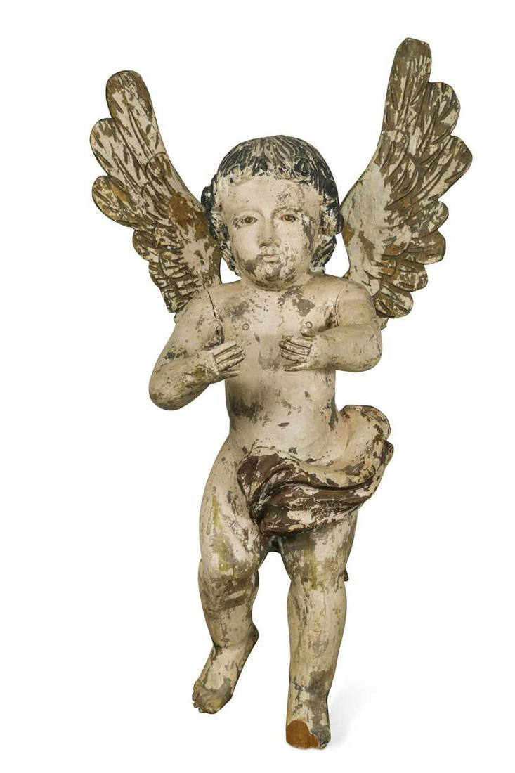 A carved painted wood cherub, 19th century,: with inset glass eyes, later hoof suspension 74cm Footnote: Provenance: Property of a late gentleman collector, Norfolk