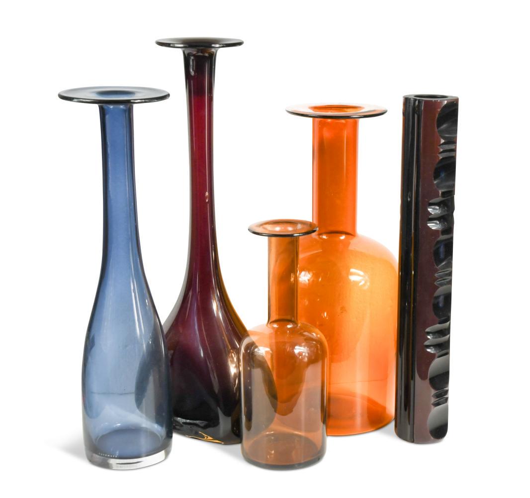 Otto Breuer (1897-1938) for Holmegaard, two glass Gul vases,: the larger in amber glass, the smaller in brown, 36cm and 25.5cm high, together with a blue cased glass totem vase, 38cm high and two further glass bottle vases, 43.5 and 39cm high