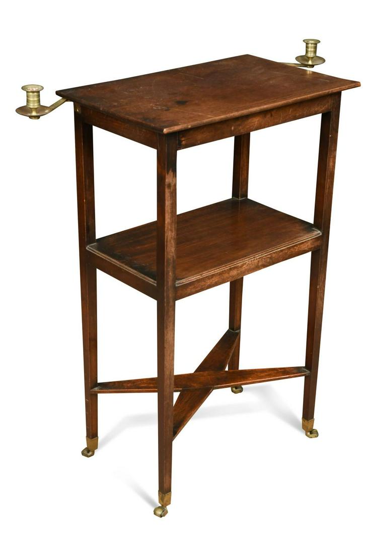 A George III small mahogany two-tier reading table,: A George III small mahogany two-tier reading table, the rectangular top with dual swivelling brass candle holders above an under-tier raised on square tapered legs united by an X-frame stretcher on br