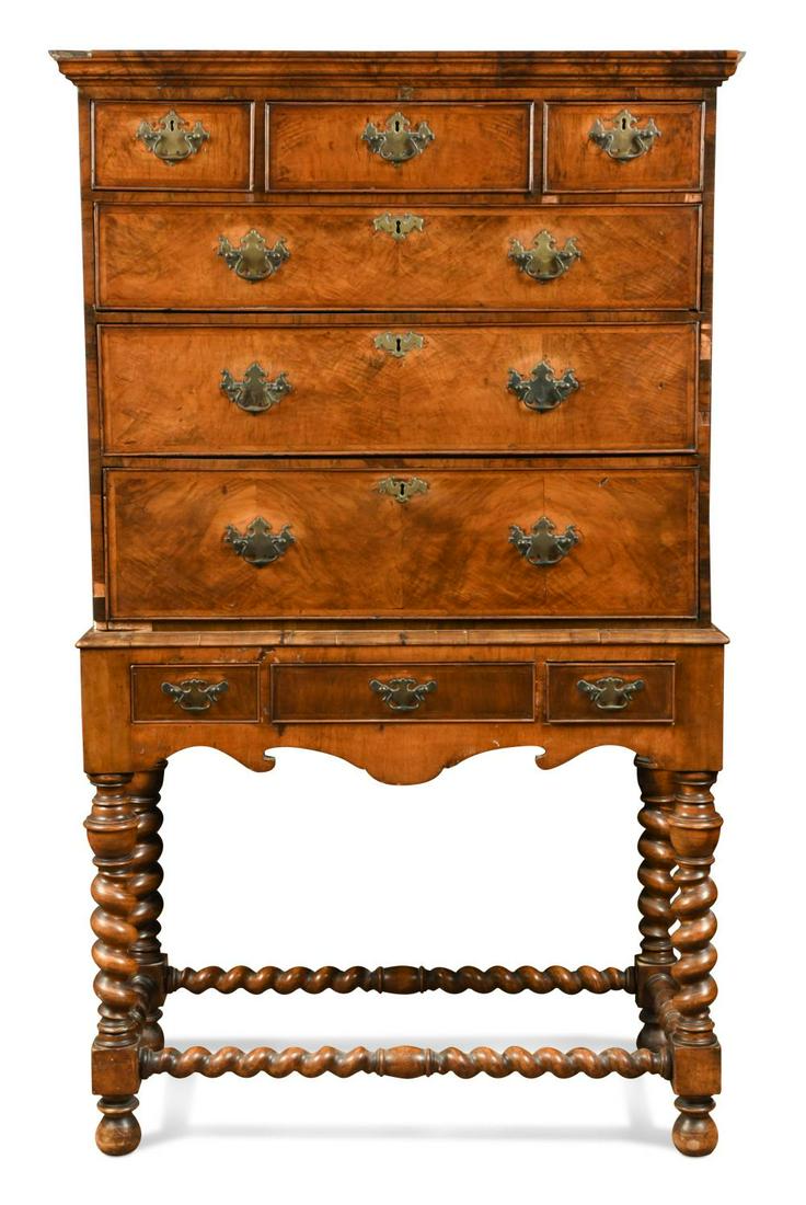 A walnut chest on later stand, 18th century,: A walnut chest on later stand, 18th century, the upper section with moulded cornice above three short and three long graduating cockbeaded drawers, the later lower section with three drawers over a sh