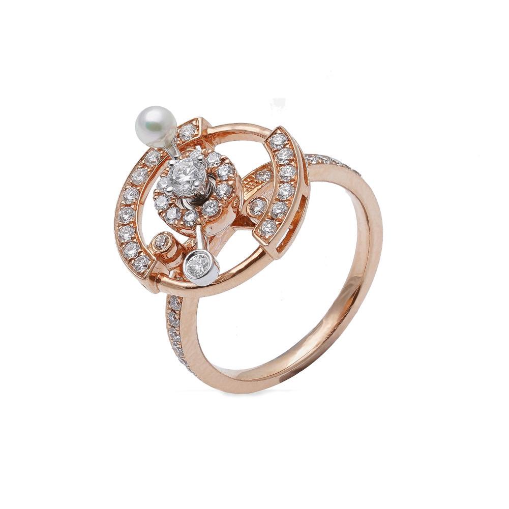 A diamond and pearl set 'petit tourbillon' ring,: claw set round brilliant cut diamond surrounded by a spinning halo of round brilliant cut diamonds and one cultured pearl, further set with a circular border of diamonds and diamond set shoulders, est