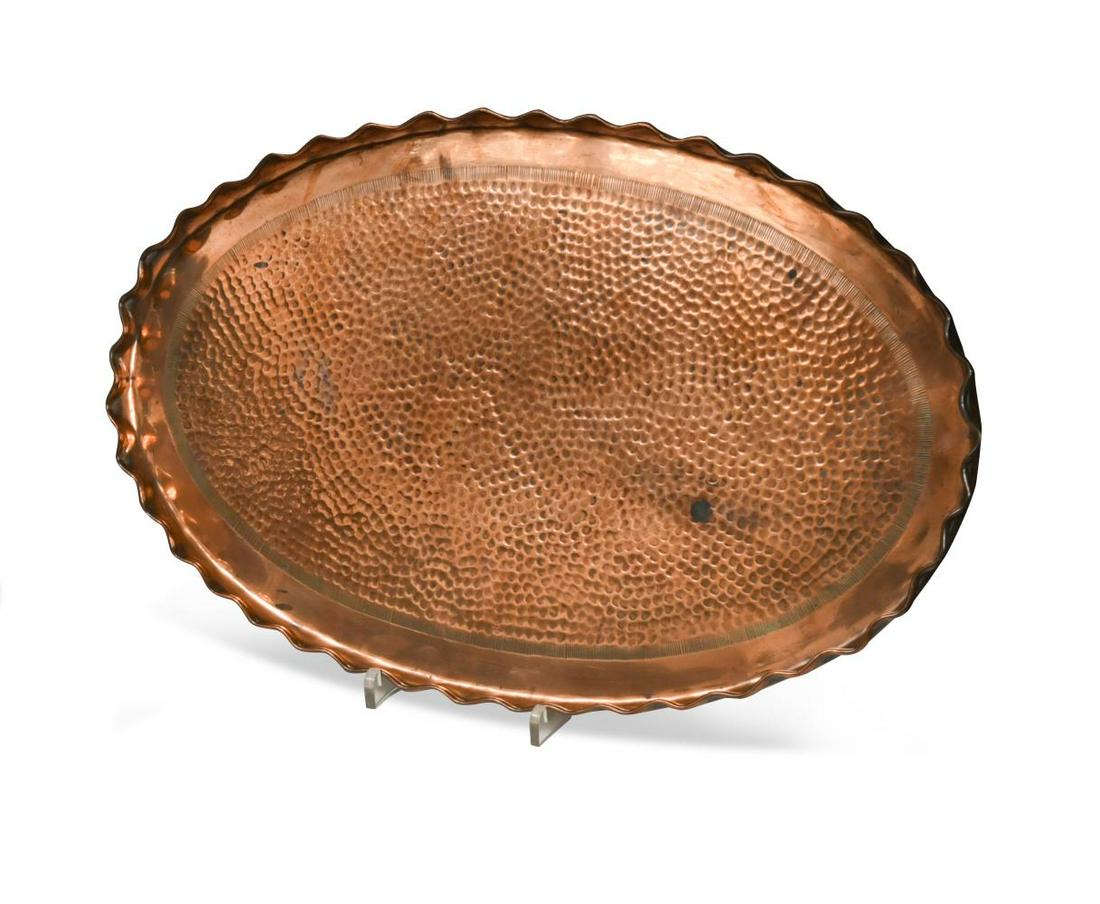 Attributed to John Pearson, an Arts & Crafts copper tray,: Attributed to John Pearson, an Arts & Crafts copper tray, retailed by Picards Ltd., of hammered oval form with scalloped rim, stamped marks 47cm wide