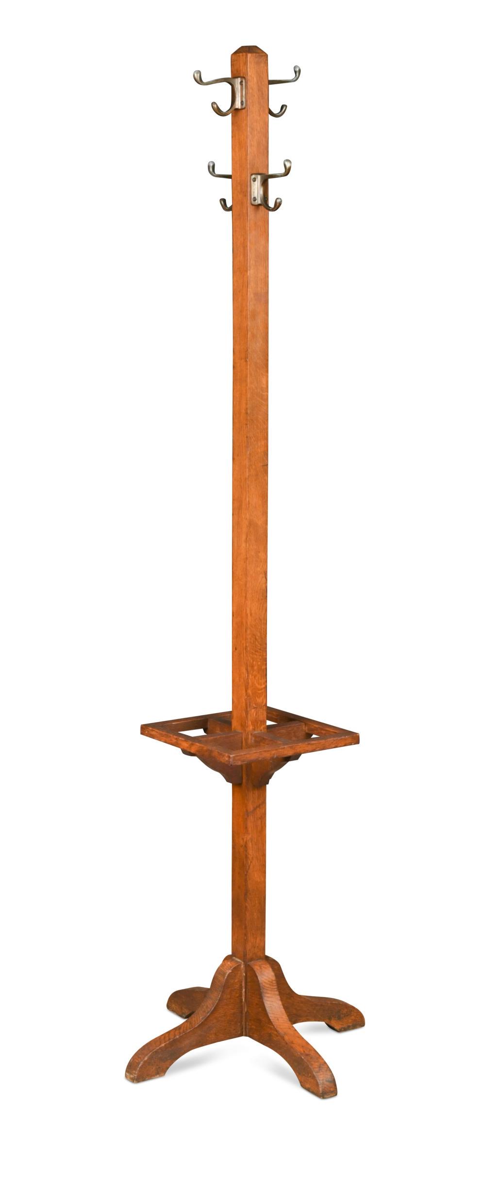 An early 20th century oak coat stand,: An early 20th century oak coat stand, the central square column with four hanging hooks and four-section stick stand 172 x 49 x 49cm