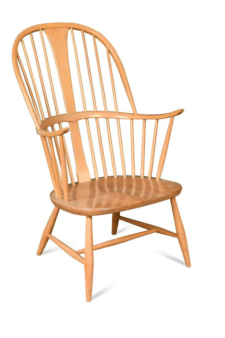 An Ercol comb-back double bow 'Chairmakers' Windsor armchair,: An Ercol comb-back double bow 'Chairmakers' Windsor armchair, with shaped seat, label to reverse 102cm high In generally good condition, a few light scuffs and marks from use, joints are opening very
