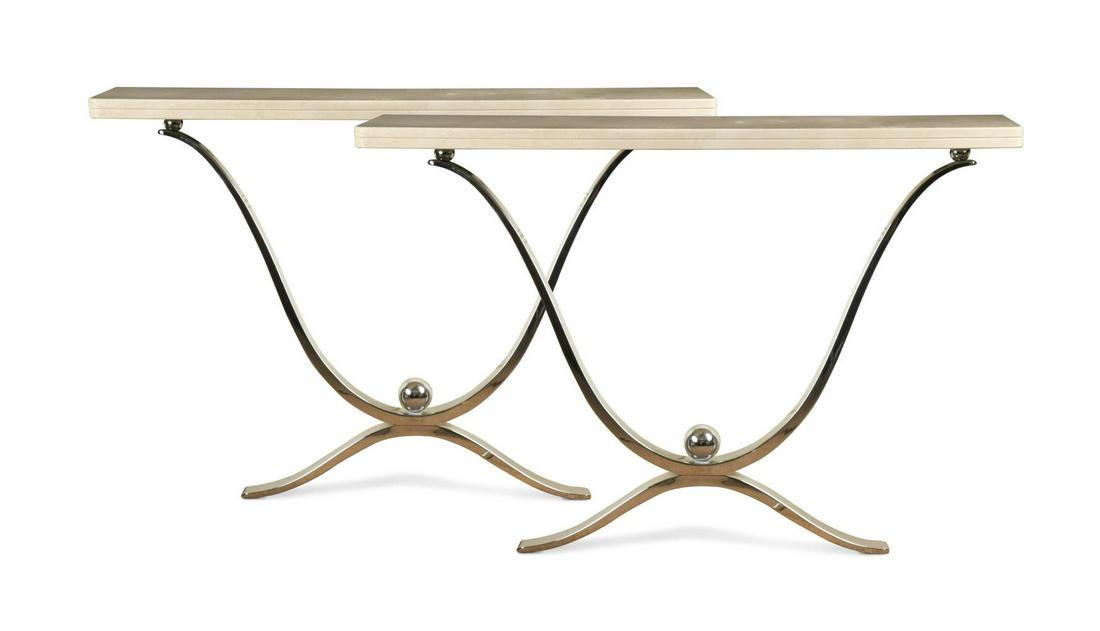 A pair of chrome and marble console tables,: A pair of chrome and marble console tables, the narrow marble tops on chrome X-frame supports with ball finials 86 x 124 x 27cm In generally good condition, require fixing to a wall, both stand at the