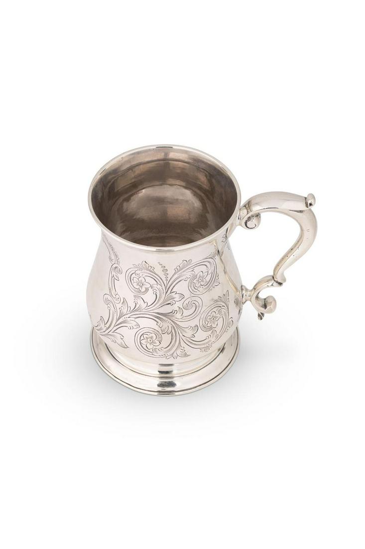 A George II silver tankard,: A George II silver tankard, mark of Benjamin West (1739 - 1750), London, date letter indecipherable, of traditional baluster form with capped double scroll handle, later decorative scroll and foliate