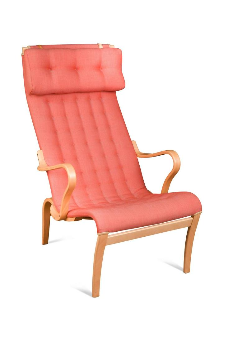 Bruno Mathsson for Dux, a modern Pernilla lounge chair,: Bruno Mathsson for Dux, a modern Pernilla lounge chair, with curved beech plywood supports and upholstered in red cotton 101.5 x 63 x 64cm