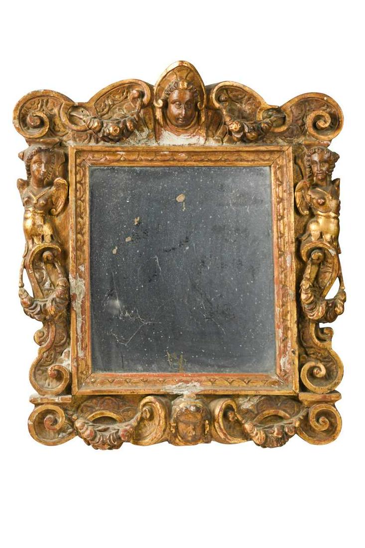 An Italian Renaissance style wall mirror, 17th century: An Italian Renaissance style wall mirror, 17th century, headed by a crowned female mask flanked by swags of fruit, the caryatid flanking figures amongst scrolls 47.5cm x 42cm Provenance: 'Hillsleigh',