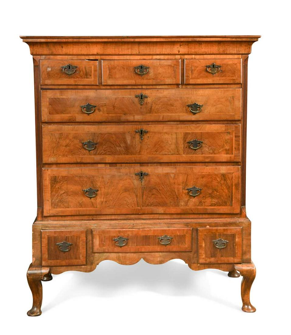 A walnut chest on stand, 18th century,: A walnut chest on stand, 18th century, the top section with three short over three long drawers flanked by fluted pilasters and raised on a later three drawer stand with cabriole legs 129 x 108 x 54cm
