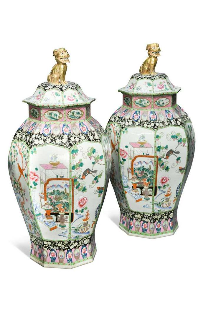 A large pair of Chinese porcelain famille rose octagonal vases and covers,: A large pair of Chinese porcelain famille rose octagonal vases and covers, the main panels painted with groups of scholars and precious objects, birds in blossoming branches, and tree squirrels, the n