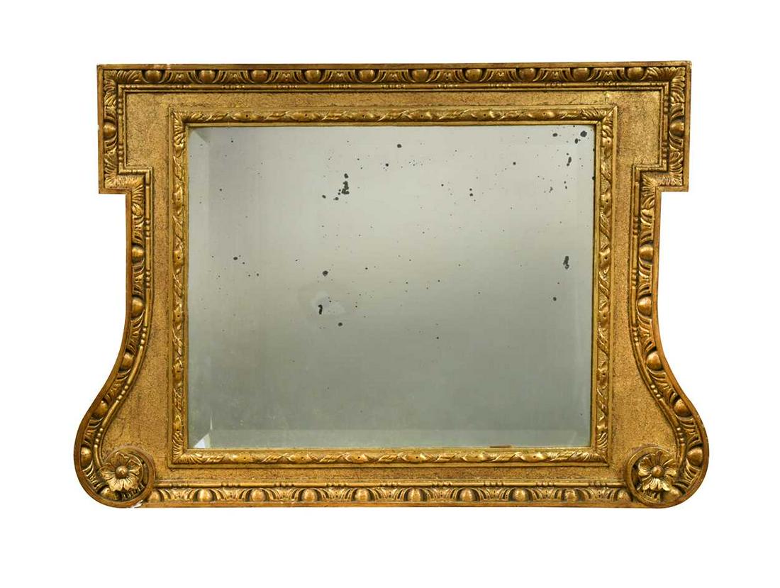 A giltwood framed overmantel mirror in the manner of William Kent, 19th century,: A giltwood framed overmantel mirror in the manner of William Kent, 19th century, the outer egg and dart border and sanded sight with re-entrant corners at the top, flowing into gently scrolling sides