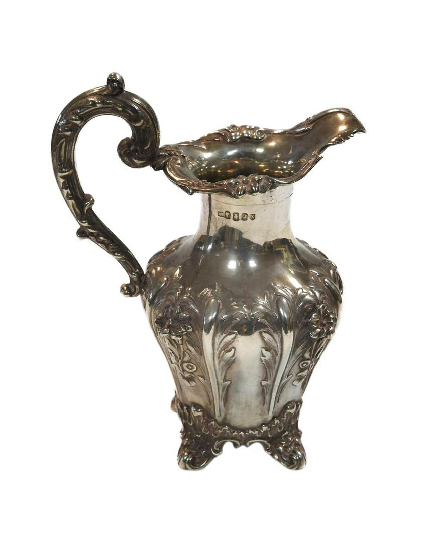 Dublin - A 19th century silver cream jug, mark of Robert W. Smith, 1868, of fluted baluster form,: Dublin - A 19th century silver cream jug, mark of Robert W. Smith, 1868, of fluted baluster form, the sides decorated with foliage and flowers, decorated rim and scroll handle, 19cm high, 10.4ozt Prov