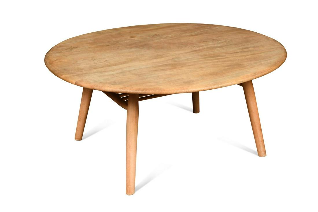 An Ercol elm coffee table,: An Ercol elm coffee table, the oval top on turned supports with undertier below, original paper label 46 x 99 x 89cm
