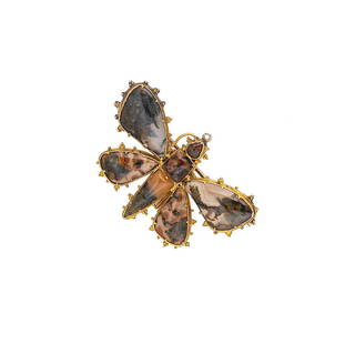 An agate butterfly brooch,: An agate butterfly brooch, realistically formed, with polished slices of agate, yellow metal frame with beaded detail, pin and hook fitting with safety chain, dimensions 5.3 x 3cm, unmarked, tested