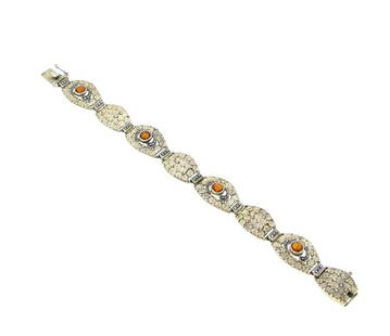 Theodor Fahrner - An Art Deco citrine and marcasite bracelet,: Theodor Fahrner - An Art Deco citrine and marcasite bracelet, eight oval shaped panels, decorated with intricate swirls, and four set with a round faceted citrine, further set with marcasite, push-in