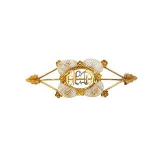 A 19th century catgut brooch,: A 19th century catgut brooch, central section with pierced initials surrounded by neatly woven catgut, mounted to pierced tapered bars with foliate terminals, pin and hook fitting, length 6cm,