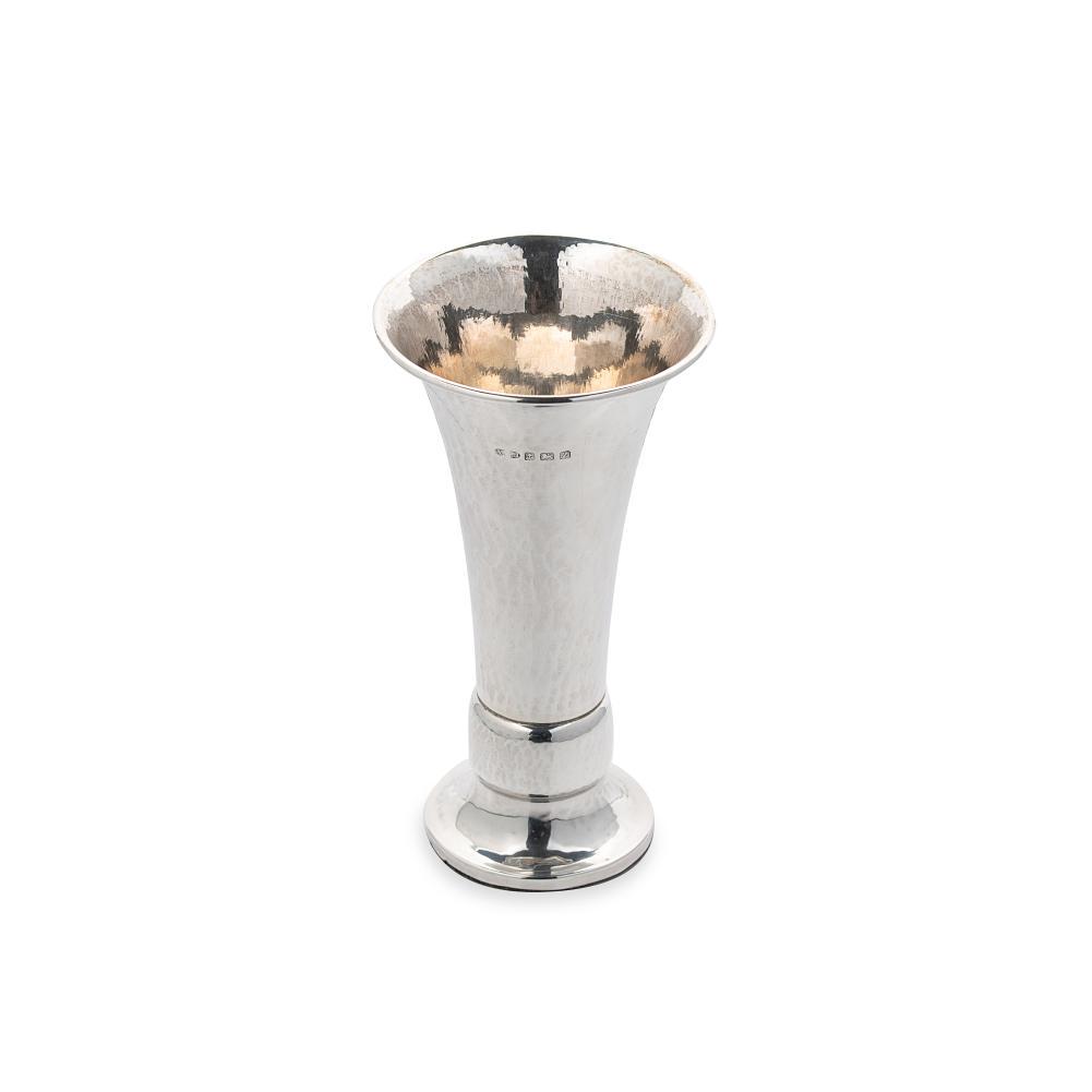A George V silver ‘Arts & Crafts’ style trumpet vase, mark of A.E. Jones,: A George V silver ‘Arts & Crafts’ style trumpet vase, mark of A.E. Jones, Birmingham 1924, of tapered cylindrical form with hammered finish, flared upper with turned rim, decorative band t