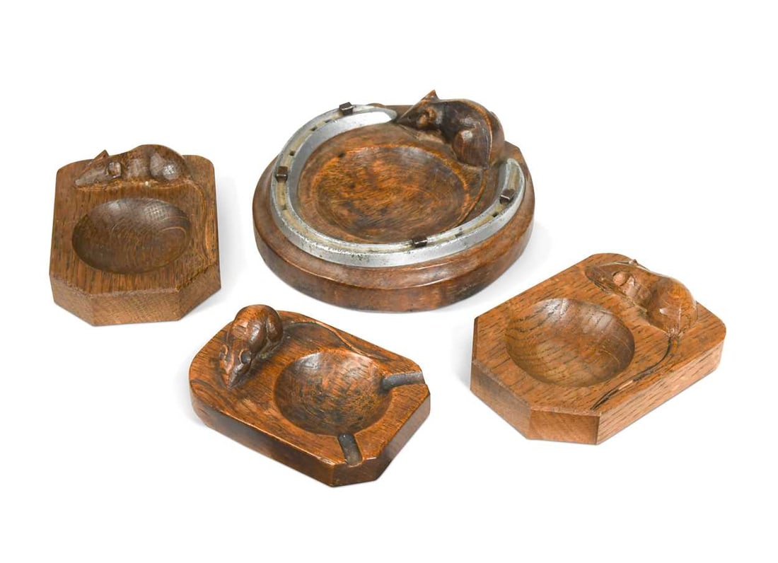 Robert 'Mouseman' Thompson, a group of four oak ashtrays, three of rectangular forms with two canted: Robert 'Mouseman' Thompson, a group of four oak ashtrays, three of rectangular forms with two canted corners, the other of circular form and mounted with a horseshoe, each carved with mouse signature