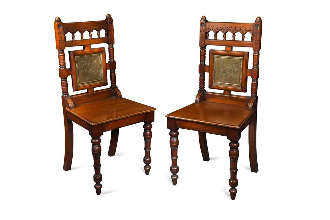 A pair of Aesthetic side chairs by Francis and James Smith, each with inset brass panel decorated: A pair of Aesthetic side chairs by Francis and James Smith, each with inset brass panel decorated with foliate motifs, enamelled labels to reverse 98cm high