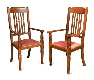 Attributed to Shapland & Petter, a pair of Arts & Crafts oversized oak armchairs, circa 1900, with: Attributed to Shapland & Petter, a pair of Arts & Crafts oversized oak armchairs, circa 1900, with shaped bar backs to wide out-curved armrests with drop-in seats, raised on square vase shaped taperin