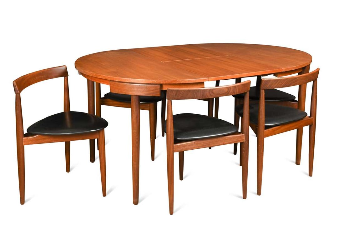 Hans Olsen for Frem Rojle, a Danish teak extending dining table and six hideaway chairs, circa 1965,: Hans Olsen for Frem Rojle, a Danish teak extending dining table and six hideaway chairs, circa 1965, the contours of the three-legged chairs designed to fit exactly around the table when not extended,