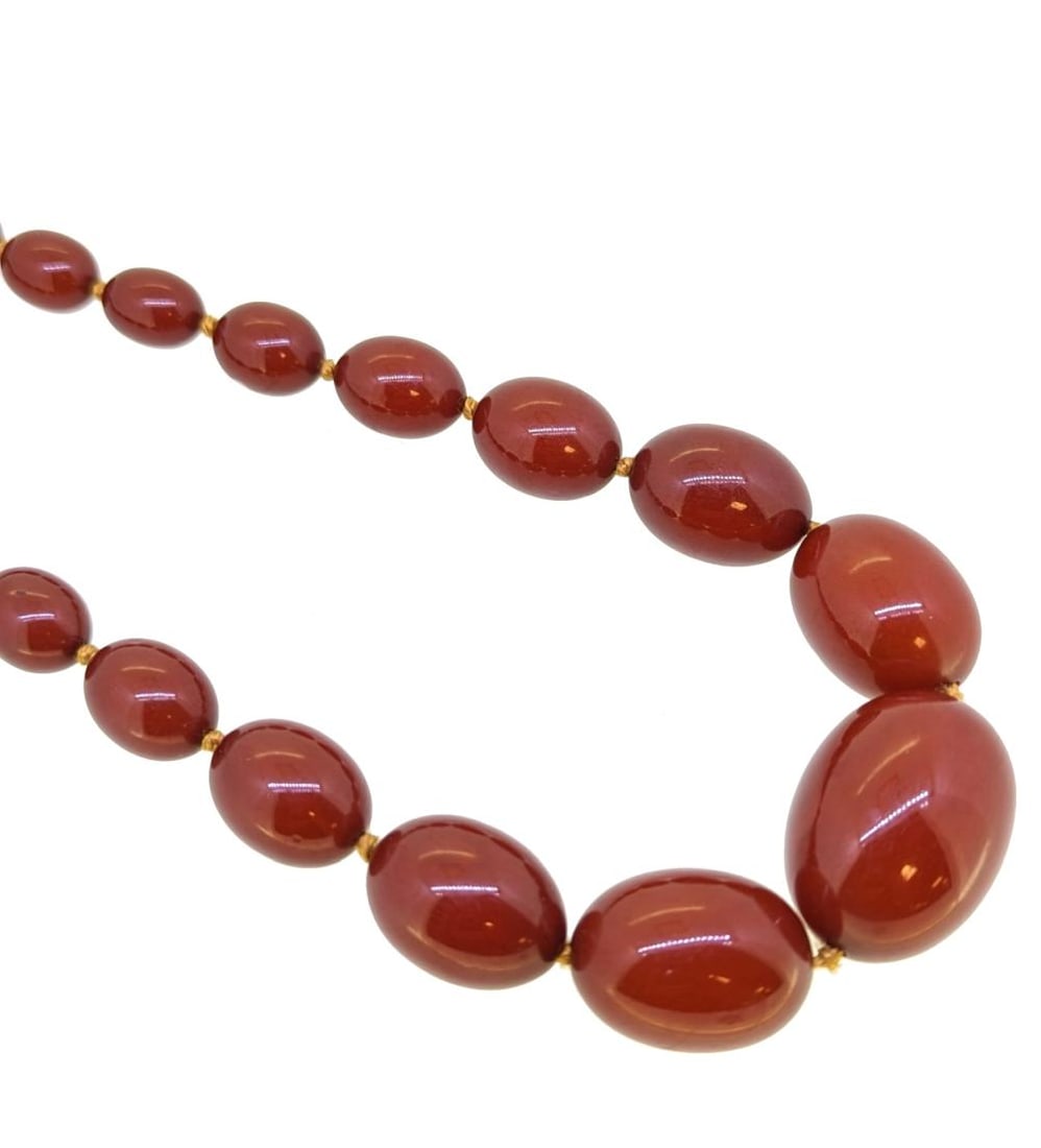 A bakelite bead necklace, thirty three graduated barrel shaped beads, from approximately 6.8 to (1 of 4)