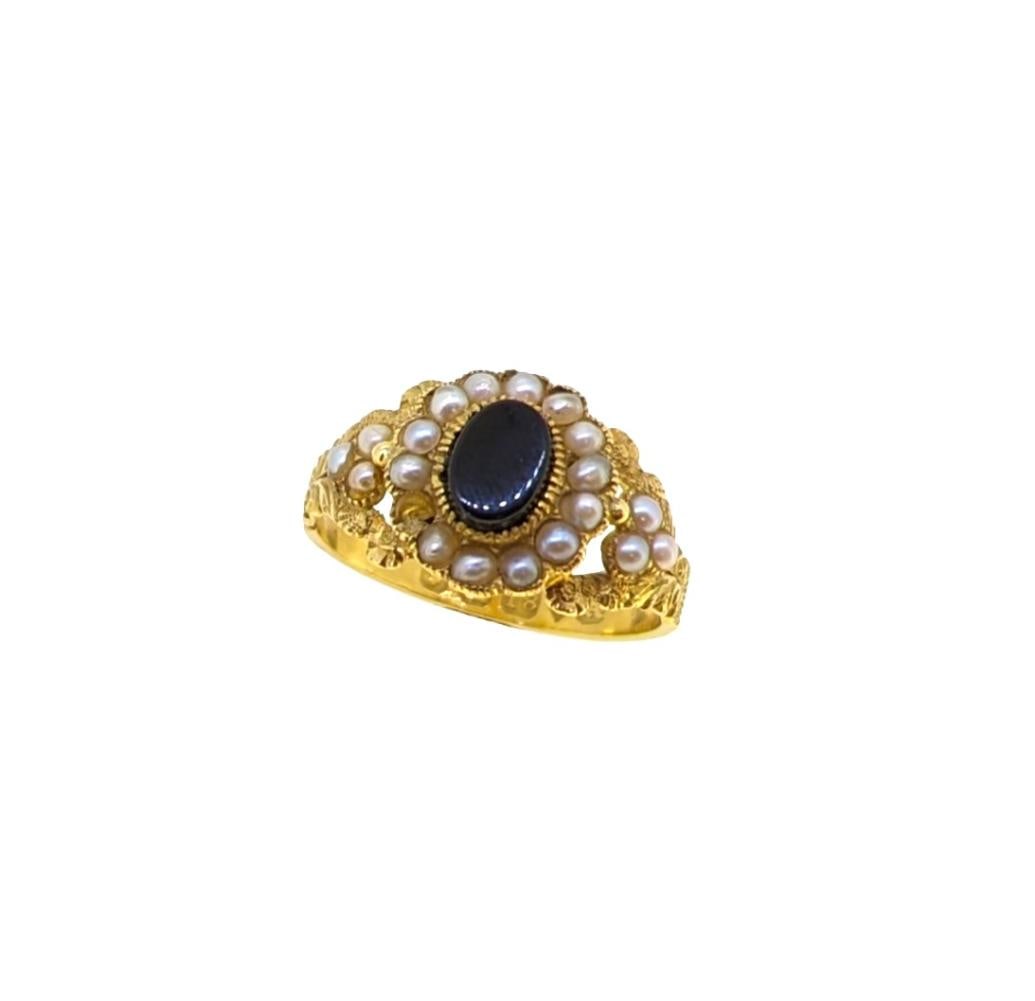 An early 19th century mourning ring, central oval shaped onyx, approximately 7 x 5mm, surrounded by (1 of 4)