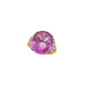 An 18ct gold pink sapphire and diamond ring, claw set oval faceted pink sapphire, approximately