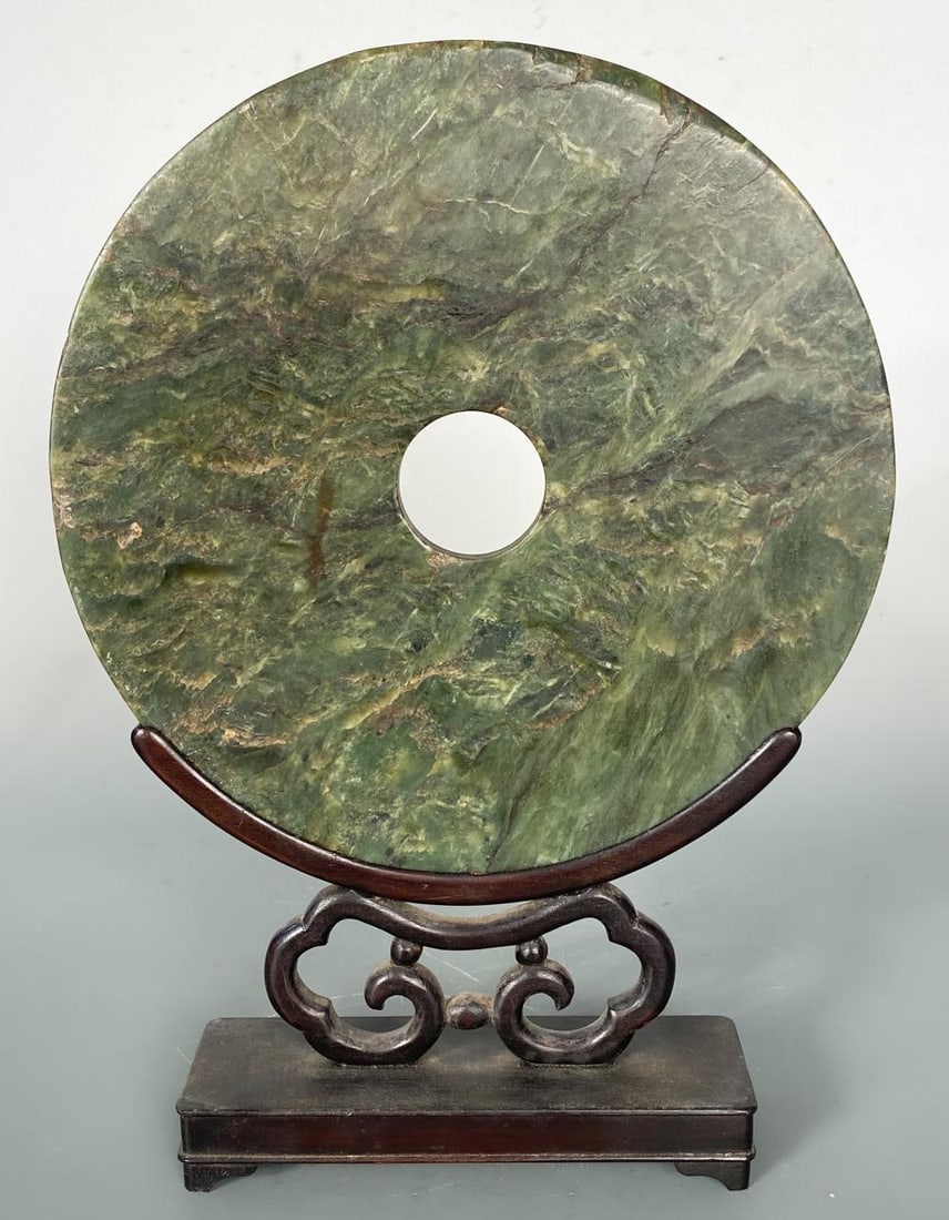 A Chinese dark green jade bi-disc, (1 of 3)