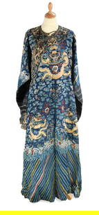 A Chinese embroidered silk blue ground dragon robe, late Qing Dynasty,: A Chinese embroidered silk blue ground dragon robe, late Qing Dynasty, worked with five-clawed sky dragons amongst clouds, over crashing waves and rock strata 180cm wide x 150cm high; A Chinese provin