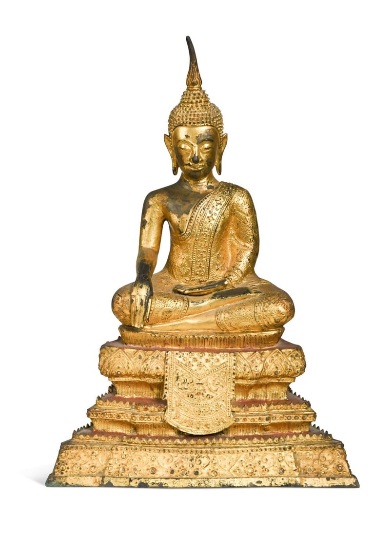 A Thai Rattanakosin gilt lacquered bronze Buddha, late 19th century,: A Thai Rattanakosin gilt lacquered bronze Buddha, late 19th century, seated in decorative robes in dhyanasana meditative pose, upon a triple-stepped trapezoidal base with frontal draped "cloth" 39 x 2