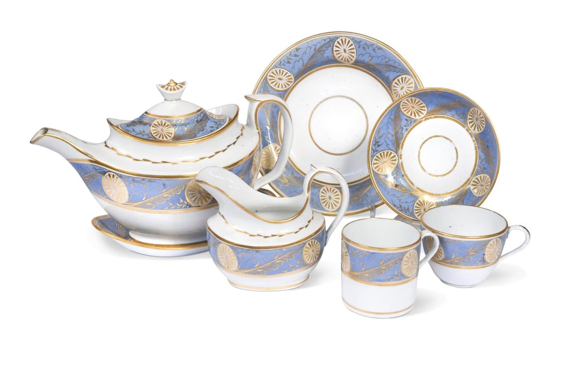 A Coalport Anstice, Horton and Rose tea and coffee service, circa 1805,: A Coalport Anstice, Horton and Rose tea and coffee service, circa 1805, decorated with gilt paterae and acanthus leaves on a pale blue band, comprising a teapot, cover and stand, sucrier and cover, mi