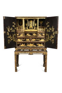 A Chinese Export lacquer and gilt cabinet on stand, late 18th or early 19th century,: A Chinese Export lacquer and gilt cabinet on stand, late 18th or early 19th century, the two doors opening to reveal a fitted interior with drawers below verandah enclosures with gilt corner columns,