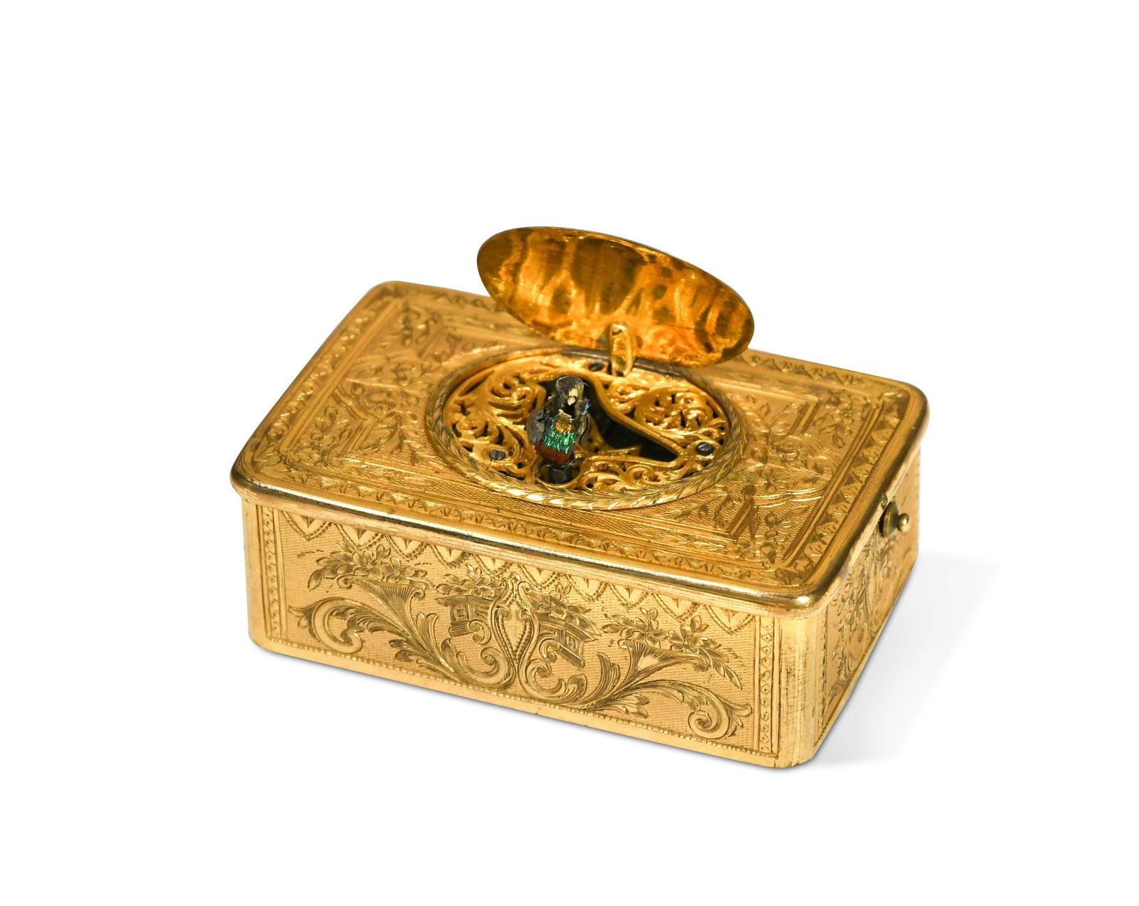 A Swiss gilt metal cased singing bird automaton, 19th century,: A Swiss gilt metal cased singing bird automaton, 19th century, with foliate scroll engraved case, a small button to one side operating the movement to reveal a sprung oval cover and a singing bird wit