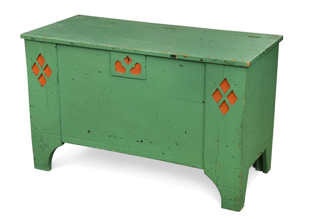 Attributed to Ambrose Heal, a Heal's painted pine coffer,: Attributed to Ambrose Heal, a Heal's painted pine coffer, of rectangular section with cut-out heart and diamond cluster decorations, painted green with coral red highlights, unsigned 62 x 99 x 49cm Pr