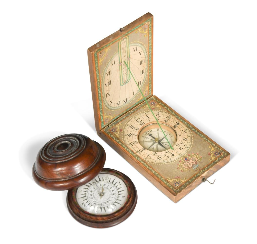 Two small pocket compasses and a miniature globe, 19th century,: Two small pocket compasses and a miniature globe, 19th century, one with hinged rectangular case enclosing printed paper sundials and inset compass, the cover with printed latitudes for American, Engl
