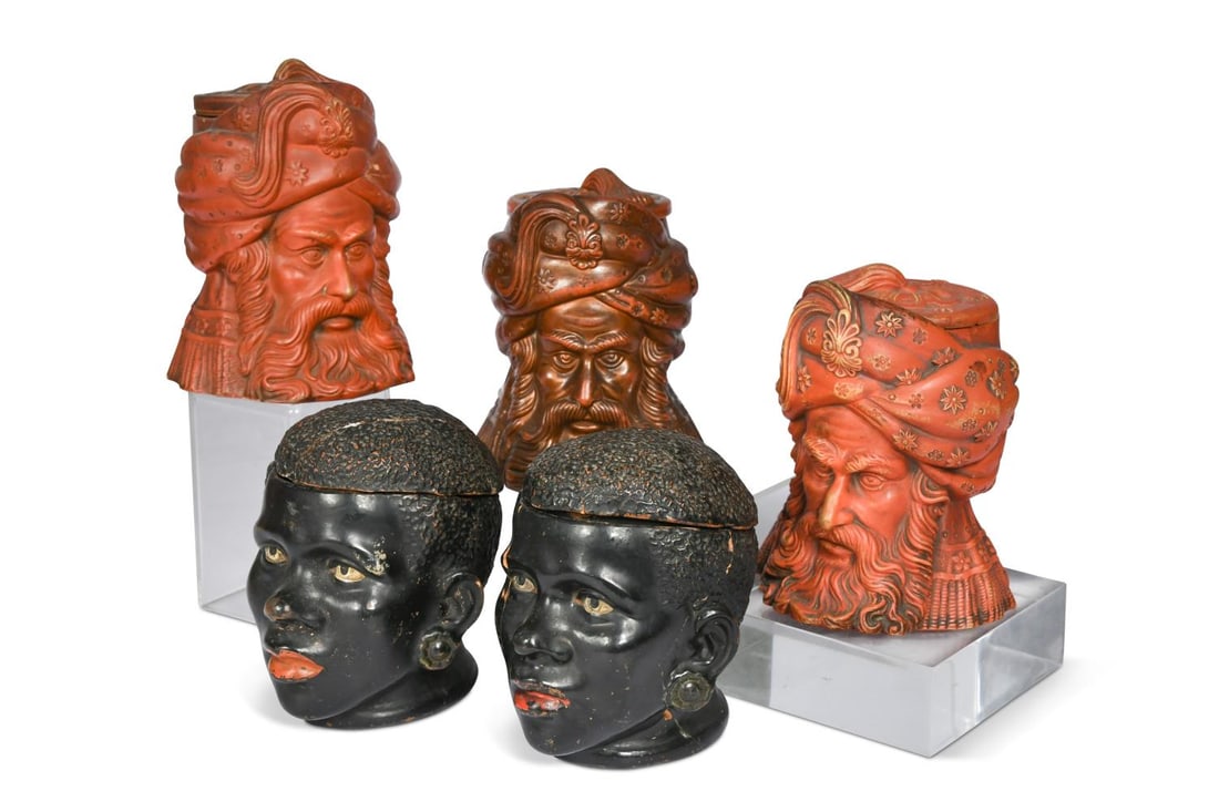 Five figural tobacco jars, 19th century,: Five figural tobacco jars, 19th century, to include three redware examples, all modelled in the Orientalist taste as three North African men and two Nubian figures, bearing N & H marks to undersides 1