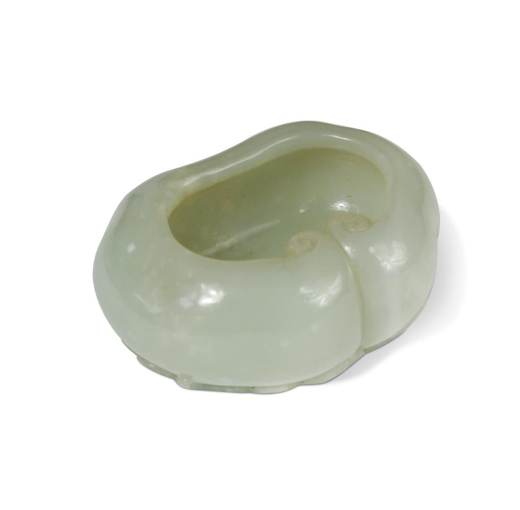 A Chinese mutton fat jade lingzhi brush washer, Qing Dynasty, 18th/19th century,: A Chinese mutton fat jade lingzhi brush washer, Qing Dynasty, 18th/19th century, the main vessel of ruyi head outline, flanked by a fungus head, further fungus heads and leaves beneath 7.3 x 3cm one t