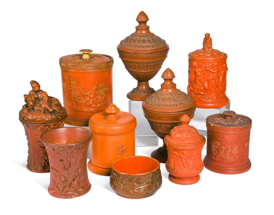 A group of nine redware tobacco boxes, mainly by Schiller and Gerbing, 19th century,: A group of nine redware tobacco boxes, mainly by Schiller and Gerbing, 19th century, one lacking cover, a shallow circular bowl, each piece relief decorated with figures or flowers (18) Provenance: Sa