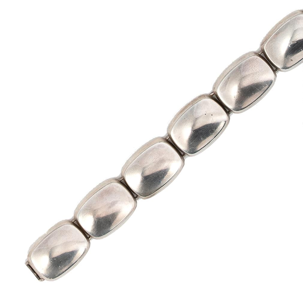 Bent Knudsen - A late 20th century bracelet,: Bent Knudsen - A late 20th century bracelet, eight concaved rectangular cushion shaped links, length 18cm, width 1.7cm, hook fitting, import mark for London, 925 silver, dated 1971, stamped 'BENT K 20